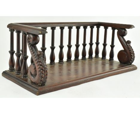 A 19th century inspired carved mahogany desk book trough with a late Victorian collection of writers' works books. The trough