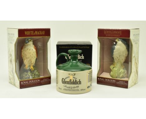 An assortment of three commemorative Scotch Whisky bottles in original cardboard boxes. The lot to include a Glenfiddich sing