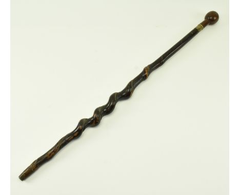 A 19th century knobkerrie type walking stick cane with spherical head with turned detail over a brass collar with barley twis