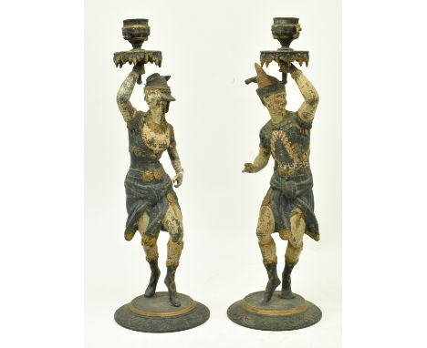 A pair of continental 19th century cold painted spelter figural candlestick holders. The pair depicting a male &amp; female f