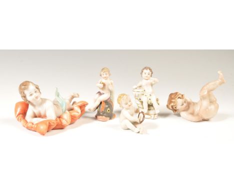 A pair of 19th century believed Carl Thieme Potschappel German cherub&nbsp; figures, one sat on a carp, the other a winged pu