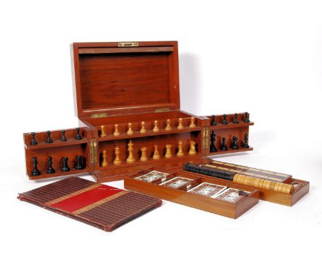 A 19th Century Victorian mahogany cased games compendium box raised on a plinth base with hinged lid and twin opening doors t