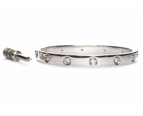 FOURTEEN CARAT WHITE GOLD BANGLE
set with round brilliant cut diamonds, 42g, with miniature screw driver for opening
