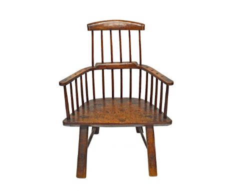 A late 18th century primitive oak stick back chair, with three piece back and solid seat, on staked supports, 80cm wide x 105