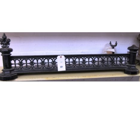 A Victorian Gothic Revival cast iron fender, with pierced frieze and octagonal supports, each with a foliate cast fleur de ly