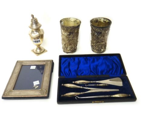 Silver and silver mounted wares, comprising; a sugar caster, raised on a square foot, Birmingham 1924, a rectangular photogra