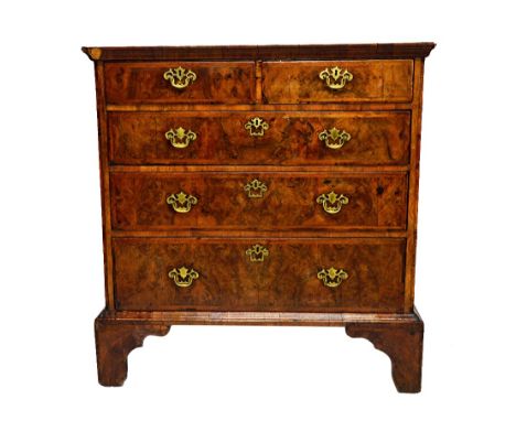 A George I feather banded figured walnut chest of two short and three long graduated drawers, on bracket feet, 101cm wide x 5