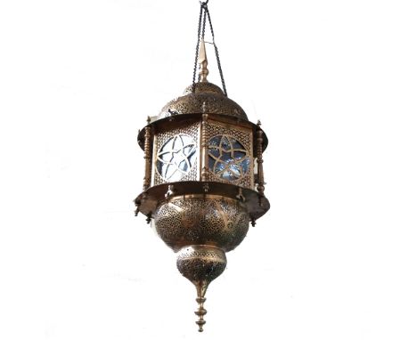 A Persian pierced brass hanging lantern, 19th century, of octagonal form, with spire finial, 70cm high.Provenance: Al-Hadeth 
