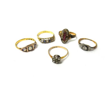 An 18ct gold, sapphire and diamond five stone ring, Birmingham 1908, a gold and platinum diamond set three stone ring, a gold