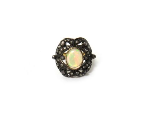 A gold and silver, opal and diamond set panel shaped ring, collet set with the oval opal at the centre, within a pierced surr