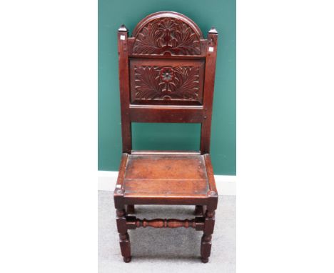 A 17th century Lancashire carved oak panel back single chair, on block and turned supports, 45cm wide x 110cm high.