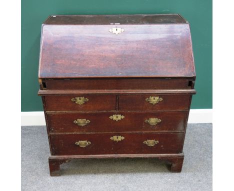 An early 18th century oak bureau, with stepped and welled interior over two short and two long drawers, on bracket feet, 92cm