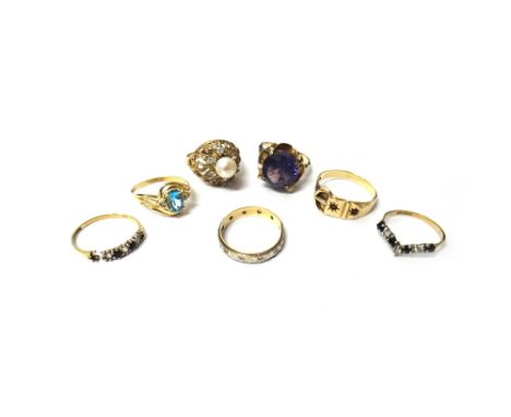 A gold, blue topaz and diamond set three stone ring, in a crossover design, detailed 14 K, a gold and synthetic corundum imit