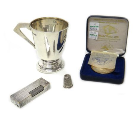 A silver christening mug, with an angular handle, Sheffield 1910, a silver thimble, Chester 1891, a silver medallion, commemo