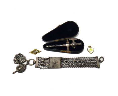 A multiple row fob chain fitted with a pendant watch key and a fob and having a central panel with floral decoration, a small