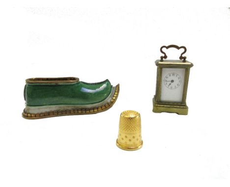 A French miniature gilt brass cased carriage clock, 5cm high, with leather bound travel case, together with a novelty porcela