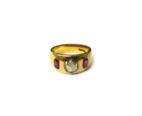 A gold, ruby and diamond set three stone ring, gypsy set with the rose cut diamond at the centre, between two cushion shaped 