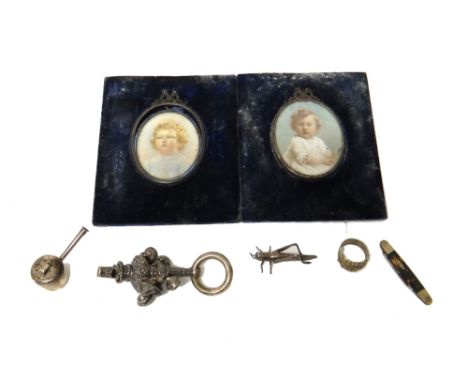 A silver baby's rattle, fitted with a ring shaped handle and with seven bells (hallmark indistinct), a pepperette modelled as