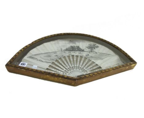 A 19th century painted paper fan detailed with a shepherd and flock, with later Chinese carved ivory sticks, housed in a gilt