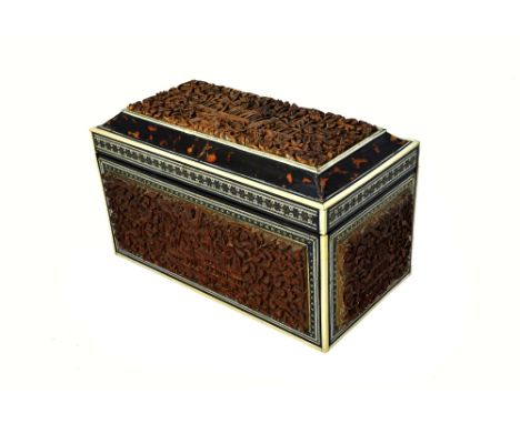 An early 19th century tortoiseshell and ivory banded Anglo-Indian carved sandalwood rectangular tea caddy, with twin lidded i