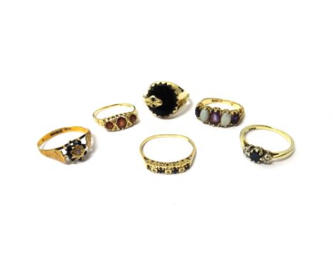 A 9ct gold, sapphire and diamond three stone ring, a 9ct gold, amethyst and opal five stone ring, a 9ct gold and black onyx s