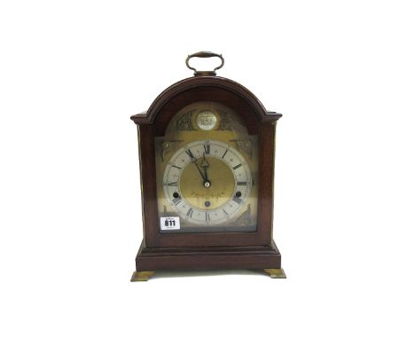 An Elliott mantel clock, with Westminster three train movement, in a mahogany case, on brass feet, 32.5cm high.