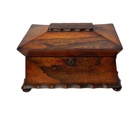 A late Regency rosewood tea caddy of sarcophagus form, with twin lidded interior, 37cm wide x 27cm deep.   Illustrated