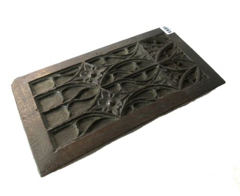 A 16th century French oak blind tracery panel, relief carved with interlocking diamonds, 20cm wide x 38cm high.