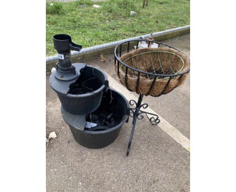 A water feature &amp; metal planter on a stand