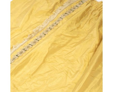THREE PAIRS OF SILK ZOFFANY YELLOW OR GOLD CURTAINS with a handmade braid trim and fringe tasselling to the edges, each curta