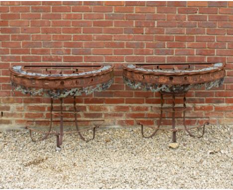 A PAIR OF 20TH CENTURY WROUGHT IRON DEMI LUNE CONSOLE TABLES with scrolling pierced top 111cm wide x 56cm deep x 79cm high (2
