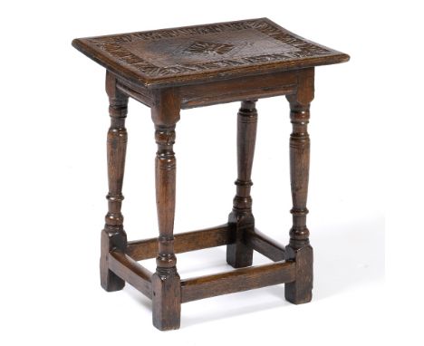 A 17TH CENTURY AND LATER OAK JOINT STOOL of pegged construction with chip carved rectangular top and tuned legs, united by st