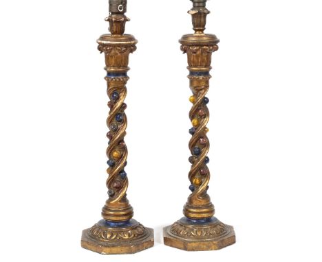 A PAIR OF 20TH CENTURY POLYCHROME AND GILT PAINTED WOODEN LAMP BASES on octagonal bases 56cm high overall (2)