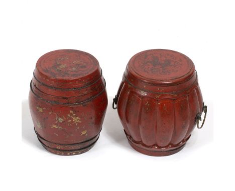 A CHINESE RED LACQUERED LIDDED BOX in the form of a drum with gilt scroll decoration, carrying handles to the side, approxima