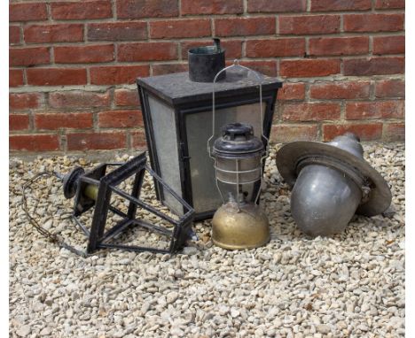 A BLACK PAINTED IRON WALL LANTERN or stable light 43cm wide x 50cm deep (for restoration) together with a tilley lamp and two
