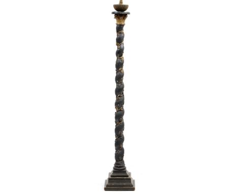 A BLACK PAINTED PARCEL GILT LAMP STANDARD in the form of a column with spiralling shaft and square spreading base, 27cm wide 