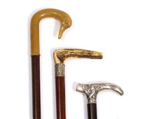 A HARDWOOD WALKING CANE with an Art Nouveau style white metal crutch handle 89cm in length, a late 19th / early 20th Century 