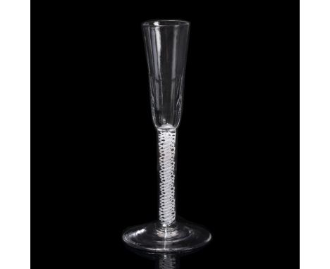 A MID 18TH CENTURY FLUTE with faceted decoration to the lower half of the bowl on an enamel double twist stem and spreading b