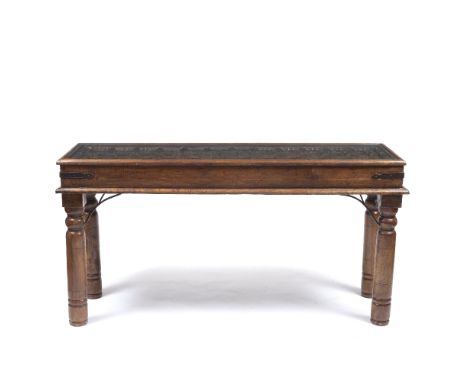 A HARDWOOD CONSOLE TABLE constructed from an Indian door with carved decoration and inset glazed top and standing on turned l