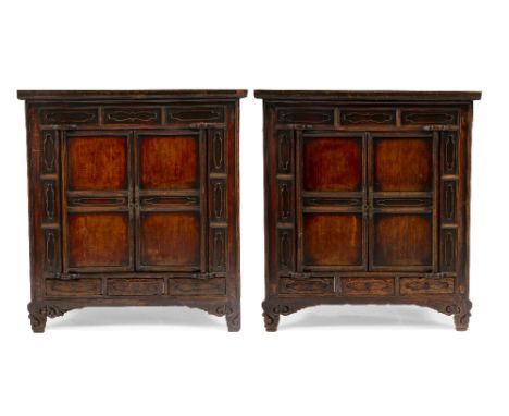 A PAIR OF CHINESE LACQUERED SIDE CABINETS  with twin panelled doors over three small drawers and standing on carved scroll fe