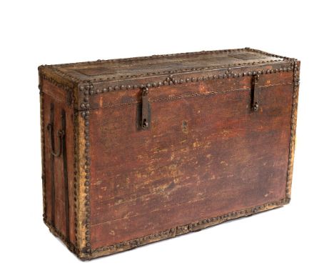 A LARGE UPRIGHT TRUNK with iron nail and hide mounted corners and carrying handles to the side 132cm wide x 45cm deep x 85cm 