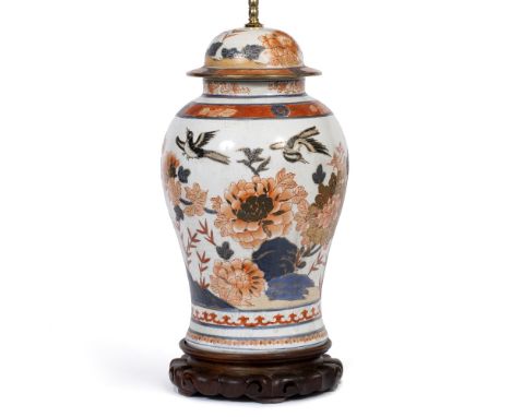 A PORCELAIN TABLE LAMP decorated in Imari colours in the style of an 18th Century Chinese vase and cover, mounted on a carved