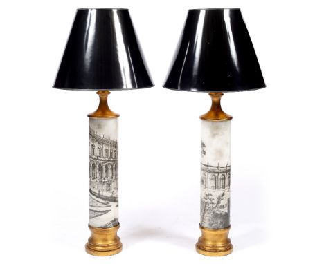 A PAIR OF CYLINDRICAL TABLE LAMPS  with turned gilt mounts in the manner of Fornasetti with black conical shades, each lamp b