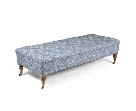 A HOWARD BUTTON UPHOLSTERED LARGE STOOL with walnut legs and brass castors, stamped to the castors (stool with alterations) 1