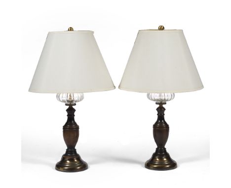 A PAIR OF CONTEMPORARY TURNED OAK AND BRASS TABLE LAMPS with faux glass reservoirs, each base 17cm wide, the lamp standing 81