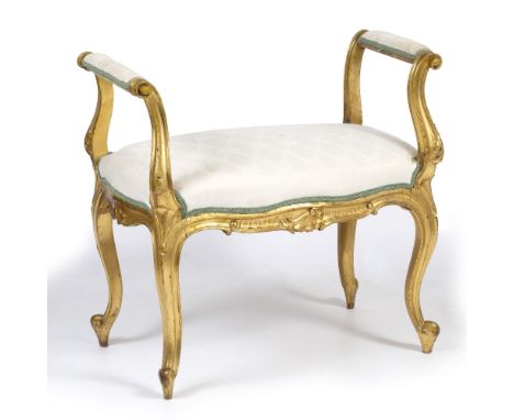 AN 18TH CENTURY FRENCH STYLE CARVED GILTWOOD DRESSING TABLE STOOL with overstuffed upholstered arms and shaped seat and stand