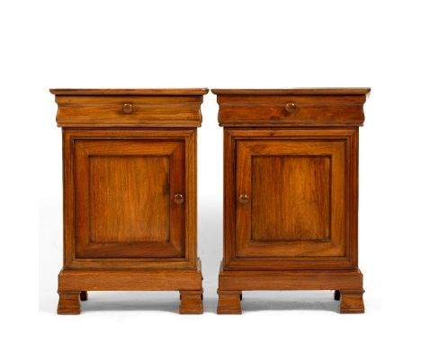 A PAIR OF HARDWOOD FRENCH STYLE BEDSIDE CABINETS each with a serpentine fronted drawer over a panelled cupboard and on bracke
