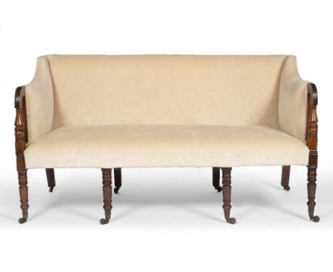 A REGENCY MAHOGANY SOFA with turned arm supports and conforming ring turned front legs terminating in brass castors 156cm wid