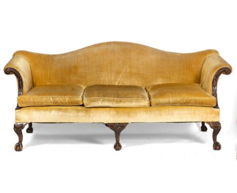 A GEORGIAN STYLE CAMEL BACK GOLD DRALON UPHOLSTERED THREE SEATER SOFA the scrolling arms carved with acorns and standing on c