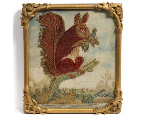 A 19TH CENTURY NEEDLEWORK TAPESTRY PANEL  of a red squirrel perched on a branch, holding a nut 23.5cm x 20cm overall 